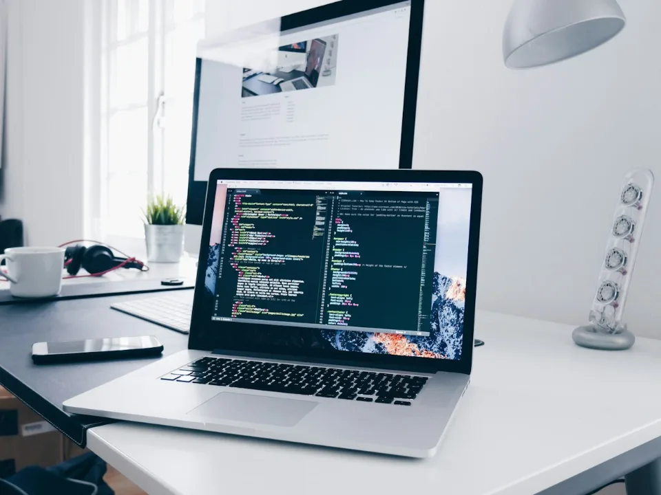 Laptop with code on a bright developer desk